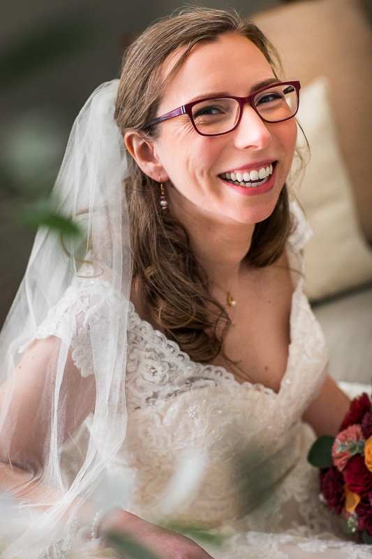 traditional portrait of the bride after she is ready smiling at the camera for her wedding in NY with creative photographer lisa rhinehart