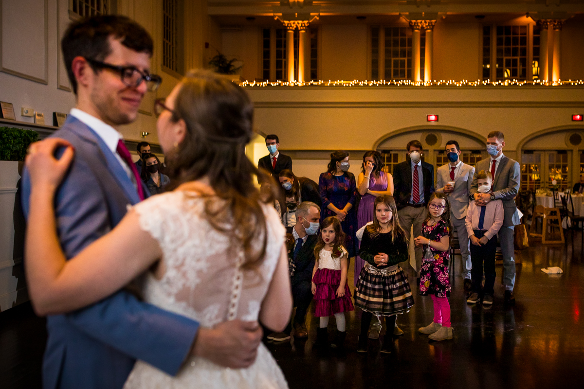 unique image of the bride and groom dancing as all the little kids watch them from the side of the dance floor during their Wedding reception