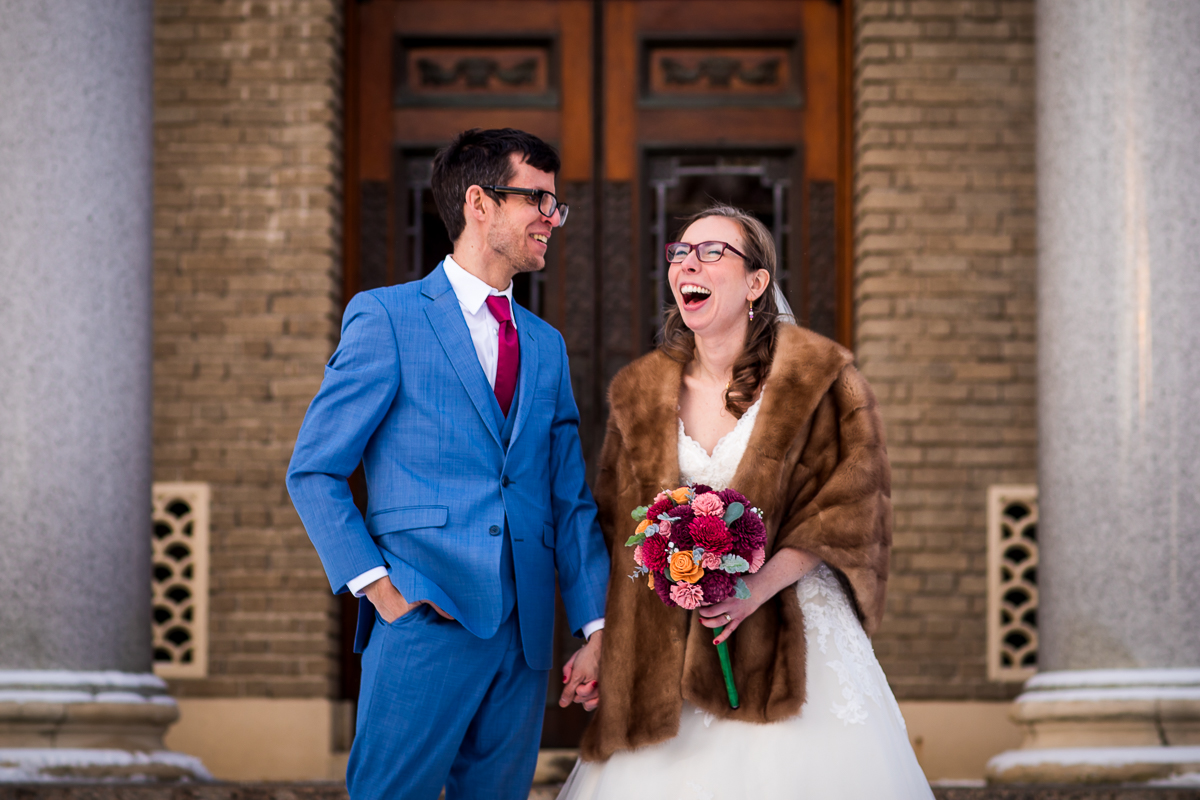 image of the couple laughing and smiling as they hold hands before their Rochester NY wedding