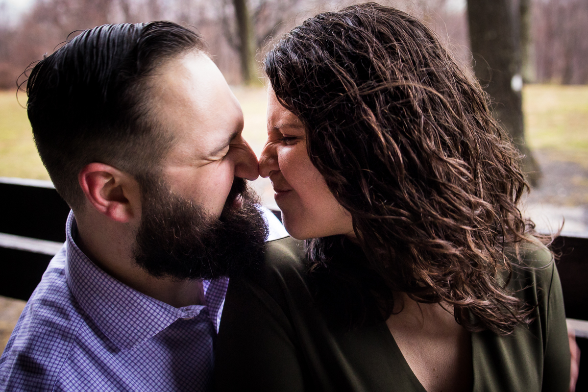 image of the couple with their noses touching during their session at misty meadow farm creamery in maryland
