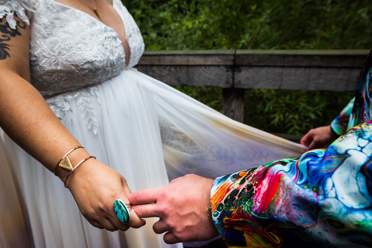 Vibrant, colorful image of this queer and trans couple holding hands during their first look at Renfrew Park in Waynesboro, Pennsylvania