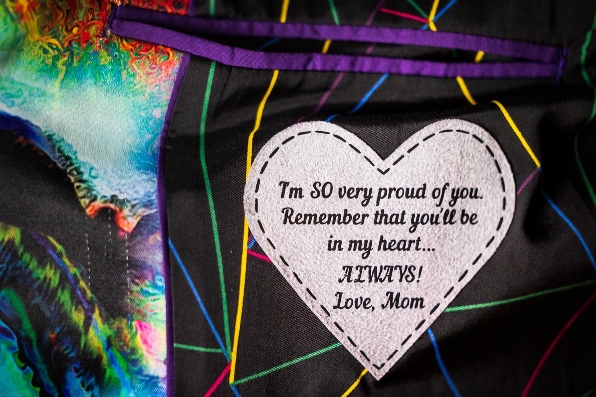 Colorful, vibrant, unqiue image of the inside of the groom's jacket of a heart with a note written by his mom captured by best LGBTQIA+ Wedding Photographer in the United States, Lisa Rhinehart