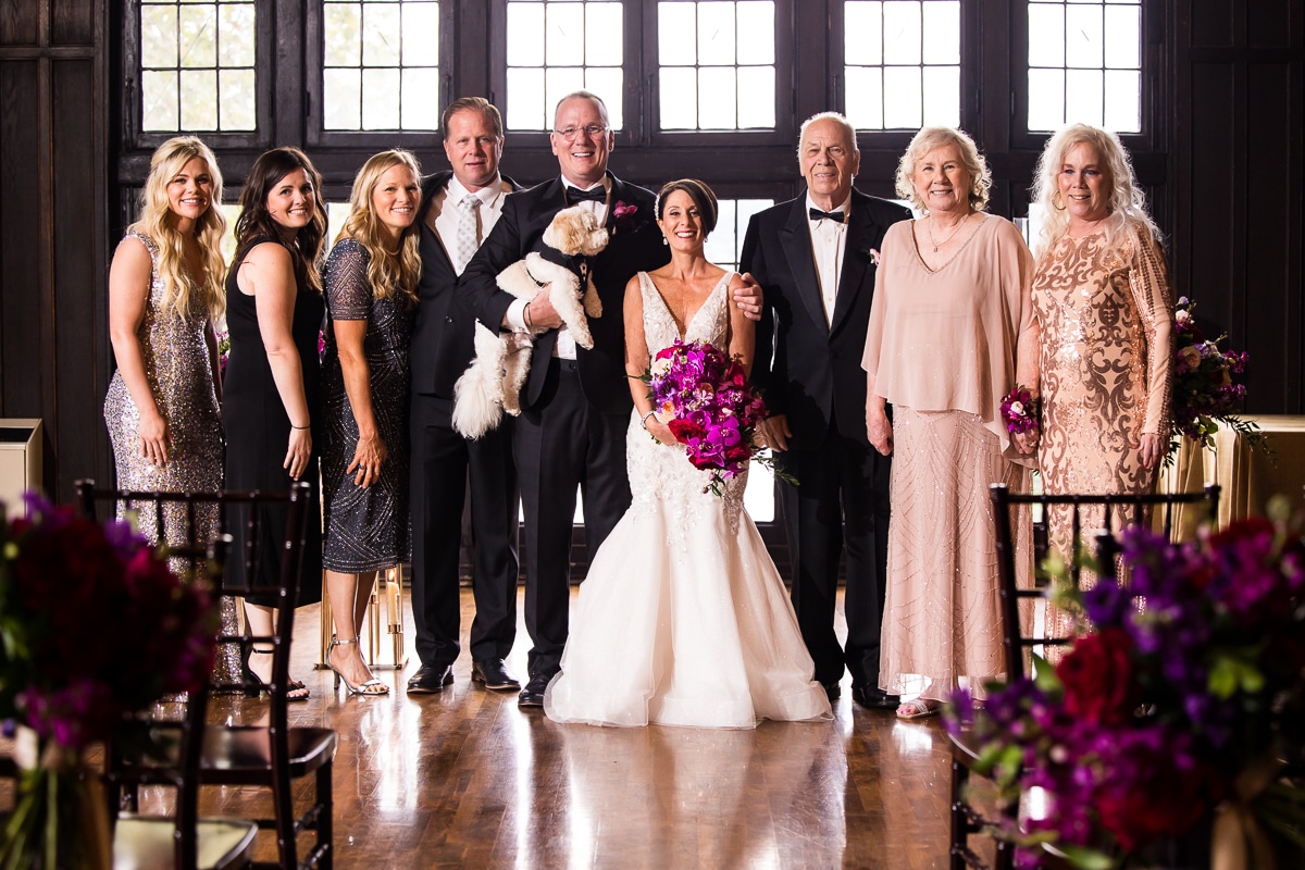 traditional portrait of the bride, groom, their dog and the family after their wedding ceremony at the Civic club of Harrisburg, this photo was taken by Lisa Rhinehart a central PA wedding photographer