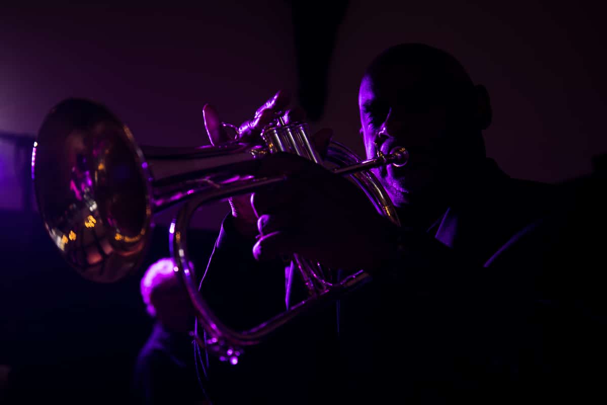 Dark, dramatic purple image of the band playing a trumpet at this Harrisburg civic club wedding reception