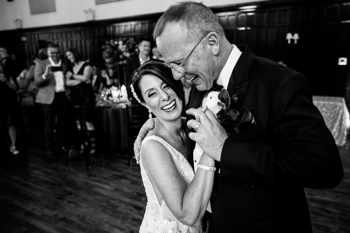 Black and white image of the bride and groom laughing with one another as they dance together at the Harrisburg civic club wedding recpetion