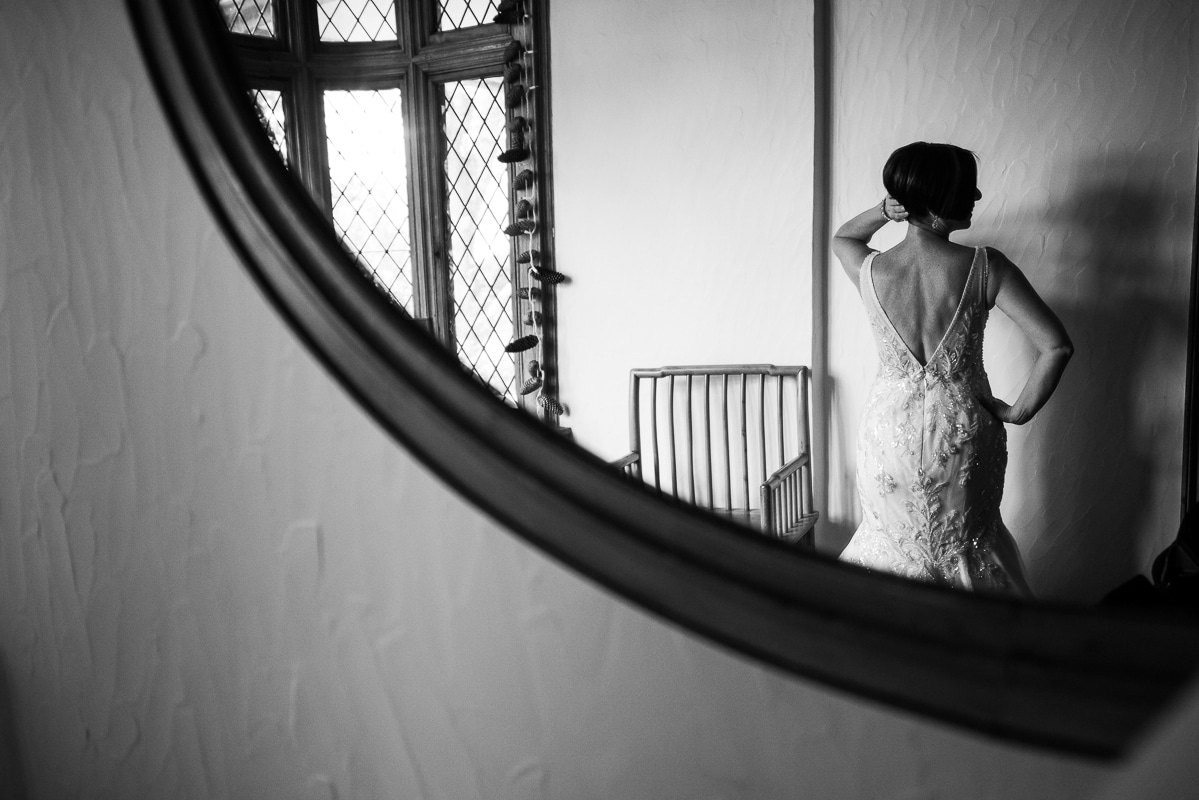 Creative photo of the bride through a mirror posing in her wedding dress for this Civic club of Harrisburg wedding
