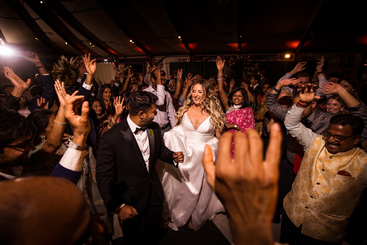 Ashcombe Mansion wedding photographer captures the bride and groom dancing surrounded by their friends and family during their wedding reception in Pennsylvania 