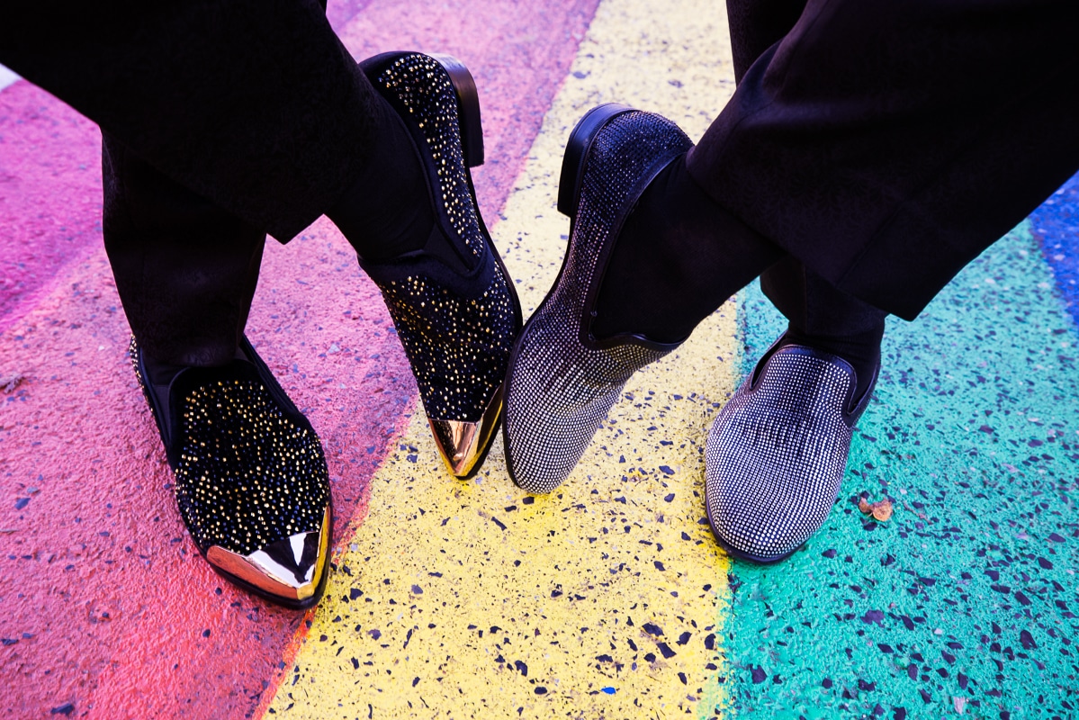Colorful, vibrant, creative image of the couple's shoes on a rainbow road in their sparkley, bedazzled shoes during their Philadelphia wedding