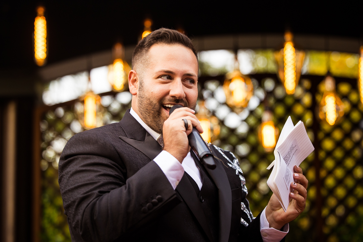 LGBT Wedding Photographer, Lisa Rhinehart, captures the groom as he shares his vows with his soon to be husband during their Philadelphia wedding ceremony 