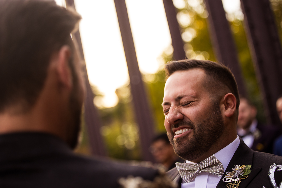 unique, creative angle of the groom laughing and smiling during their wedding ceremony at the Phoenixville foundry in pa