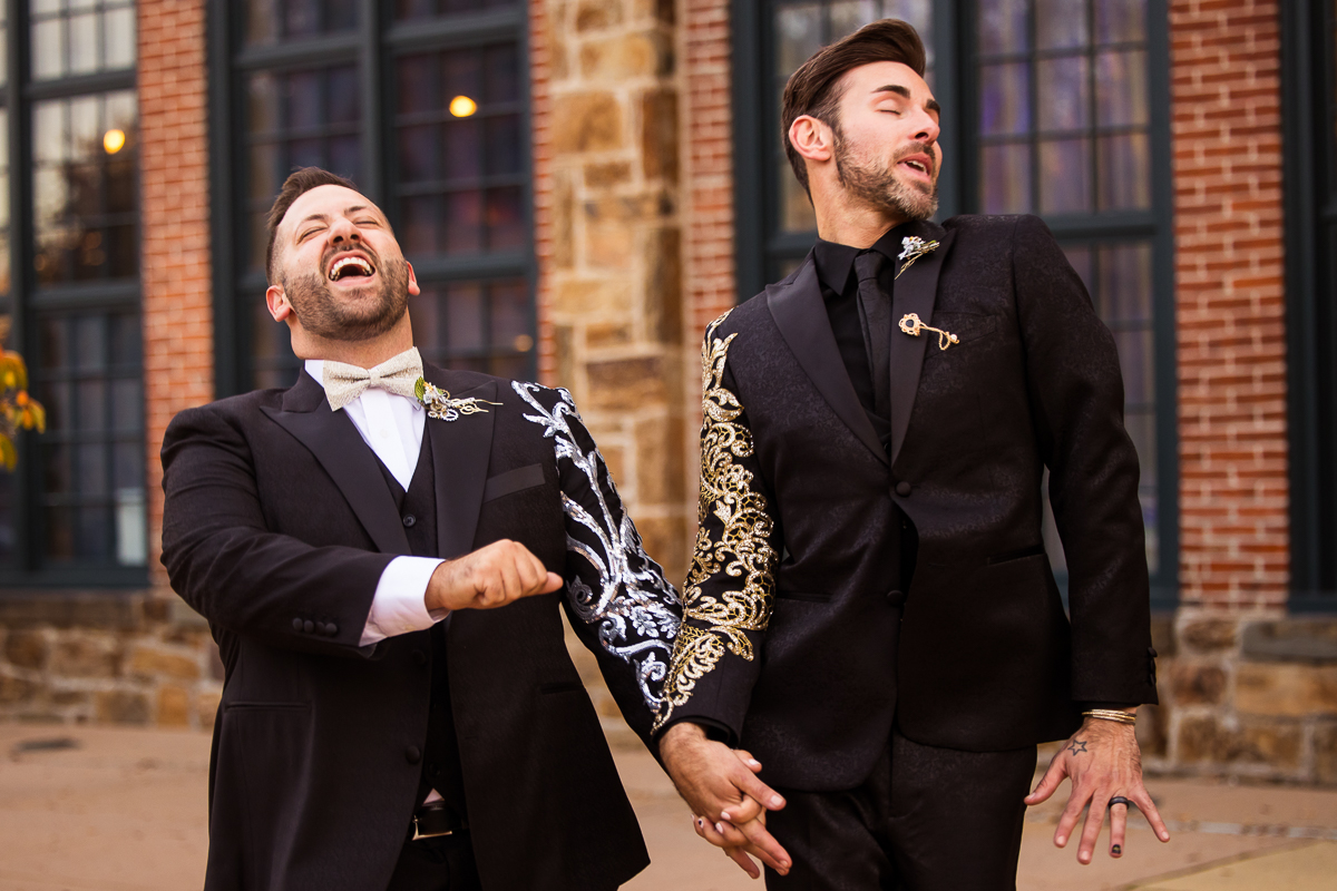 unique image of the couple laughing and smiling as they walk around after their wedding ceremony at the Phoenixville foundry 