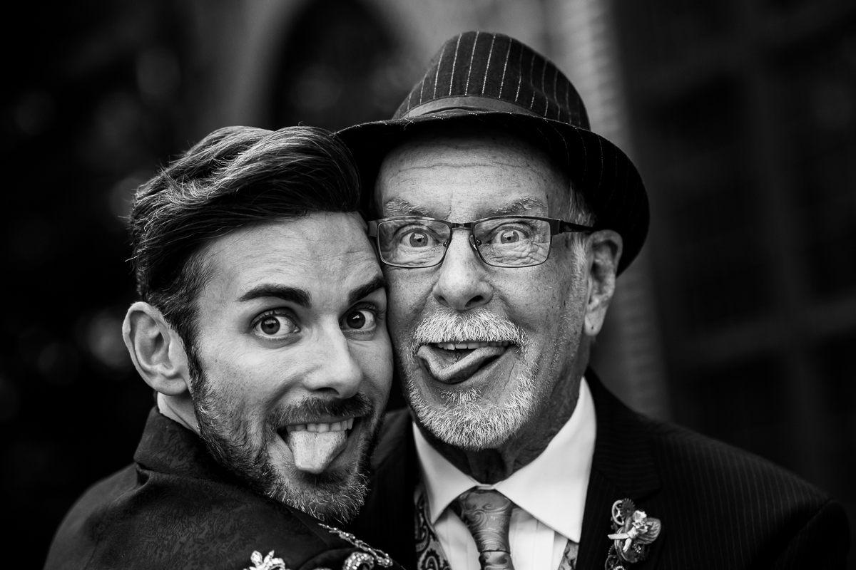 black and white image of the groom with their pop pop as both of them stick their tongues out for a picture with Philly photographer Lisa Rhinehart