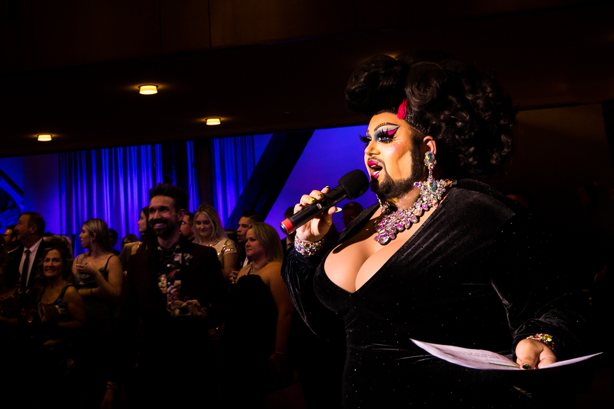 Image of a drag queen making all of the announcements during this philly gay wedding reception 