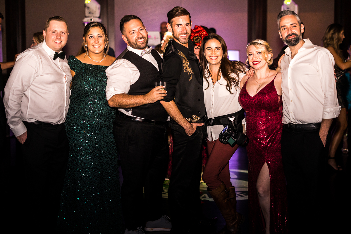 LGBT Wedding Photographer, Lisa Rhinehart, standing with all a group of all her clients that have been a part of this family 