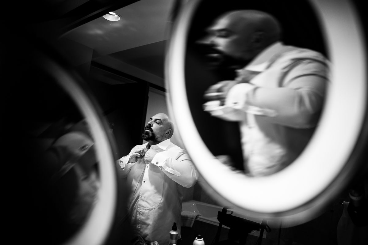 Ritz Carlton Georgetown Wedding photographer, rhinehart photography, captures this unique, creative, black and white image of the groom getting ready and all of his reflections that are caught in the mirrors around him