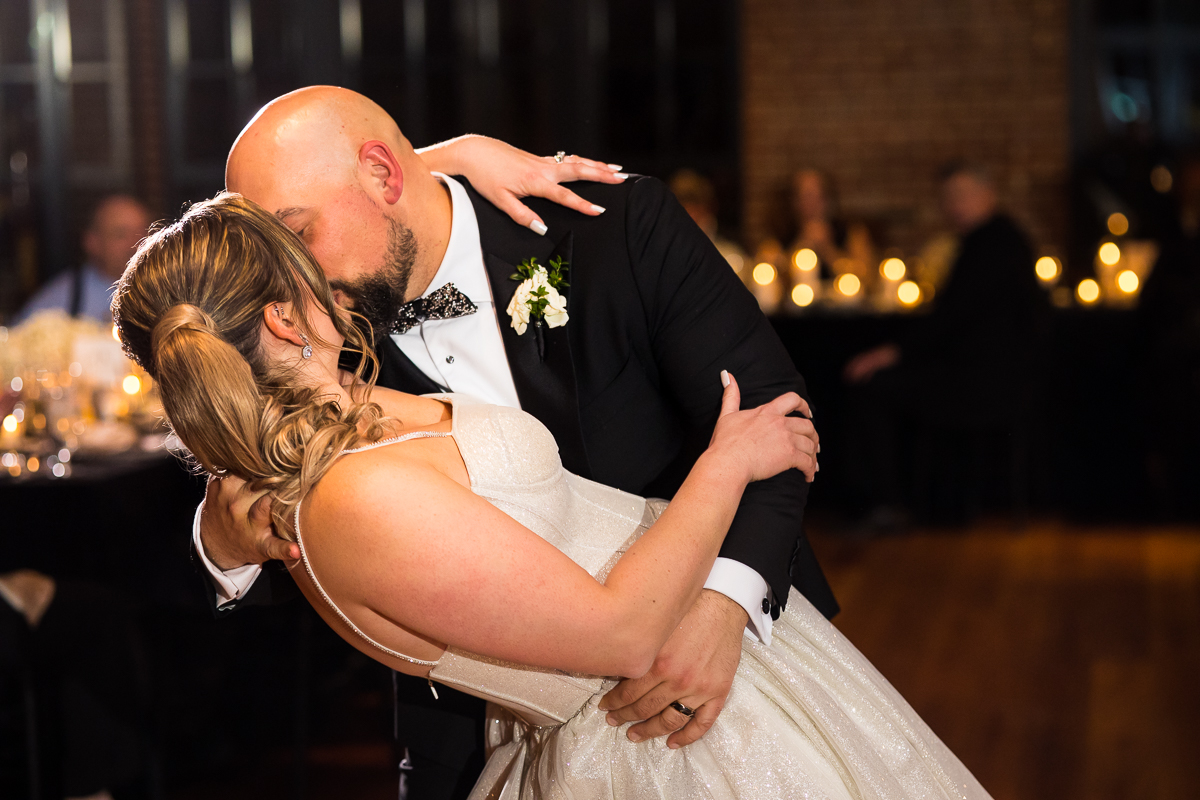 The bride and groom share a kiss during their wedding reception and their first dance during their Ritz Carlton Georgetown Wedding reception 