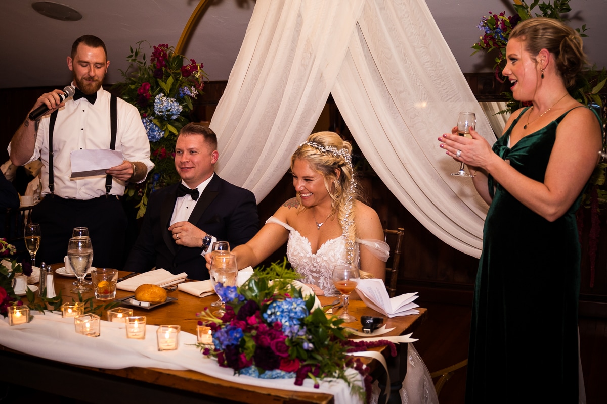 stroudsmoor photographer, lisa rhinehart, captures the couple laughing and smiling as their best man and maid of honor give their speeches during the wedding reception
