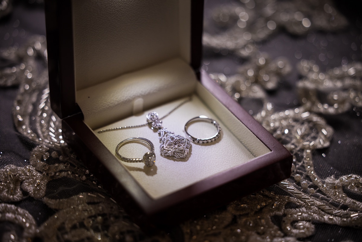 image of the brides jewelry for the day which has her rings and a special necklace from her grandfather