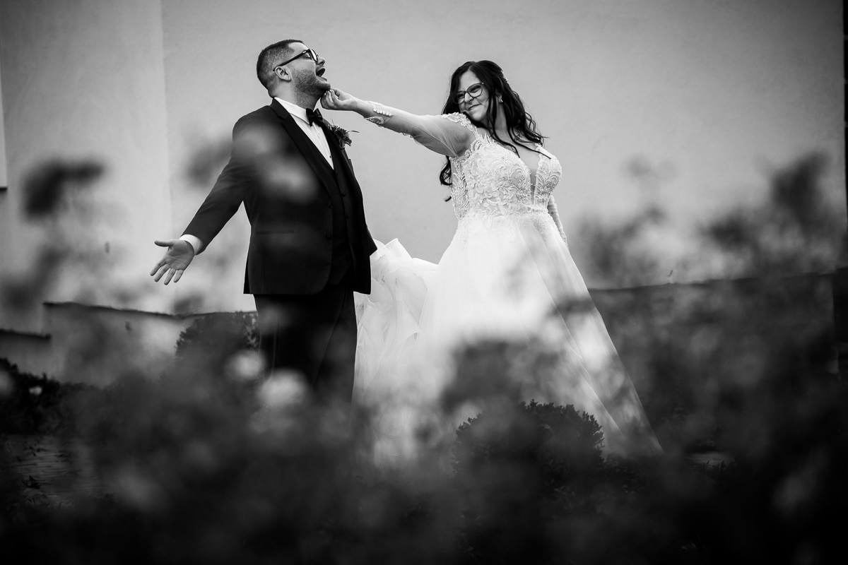 Ryland Inn Wedding Photographer, lisa rhinehart, captures the bride tickling the grooms chin as he has his hands out with his mouth open laughing before their wedding ceremony at the ryland inn 