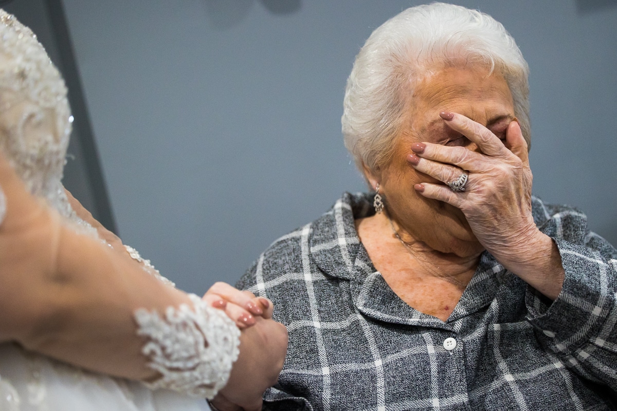 Ryland Inn Wedding Photographer, lisa rhinehart, captures the authentic moment of when the brides grandma sees her for the first time in her wedding dress and she is covering her face trying not to cry 
