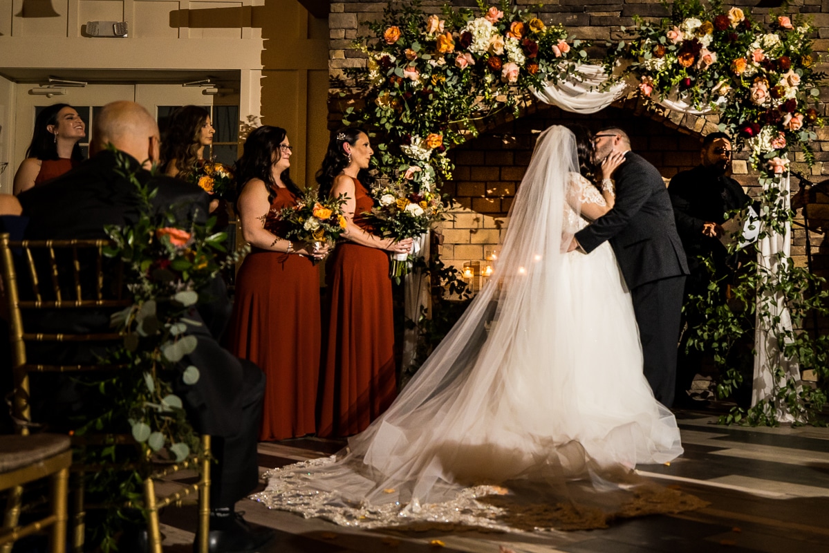 Ryland Inn Wedding Photographer, lisa rhinehart, captures the couple as they share their first kiss during their wedding ceremony at the ryland inn 