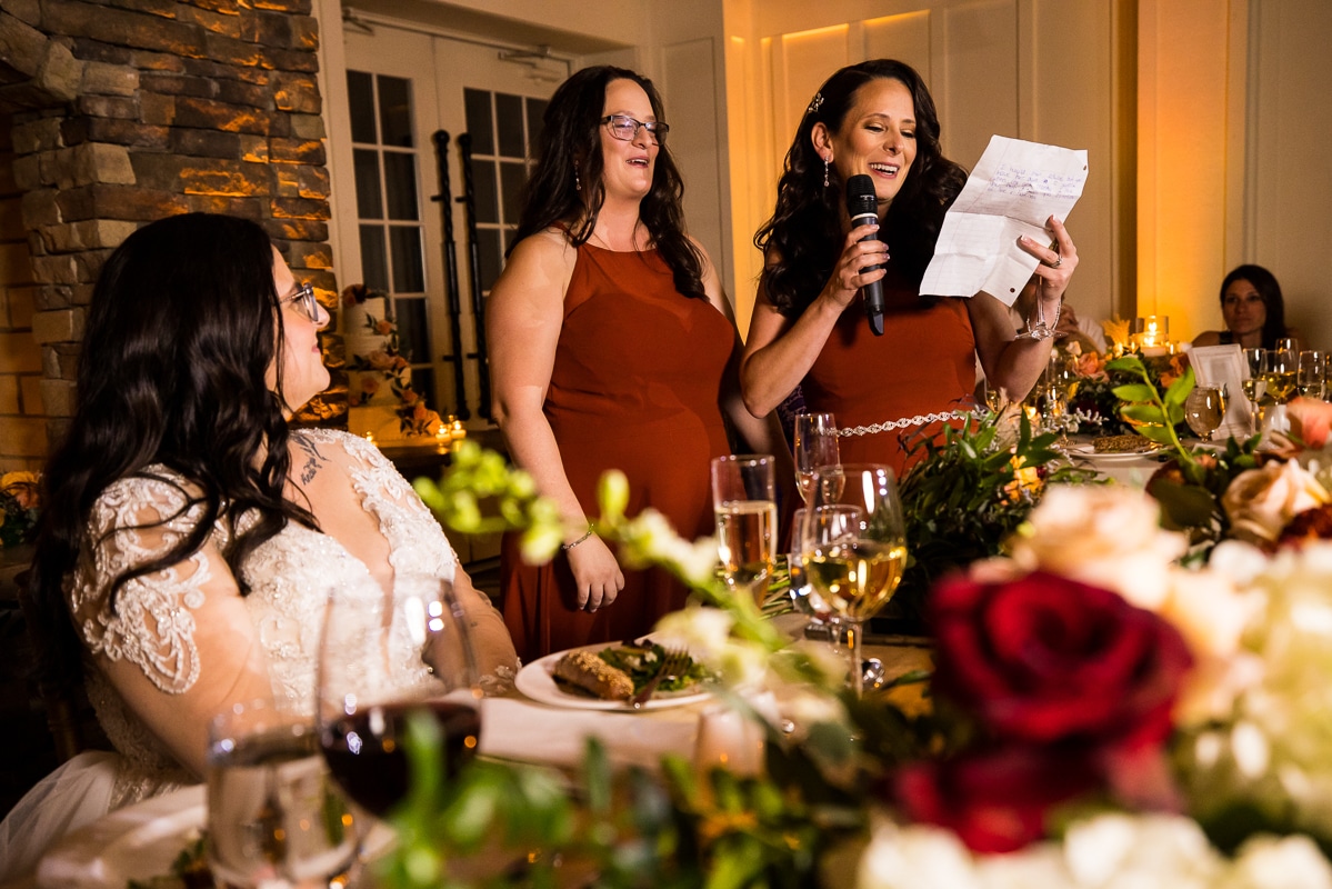Ryland Inn Wedding Photographer, lisa rhinehart, captures the two sisters of the bride as they give their speech to her during the wedding traditions part of the reception 