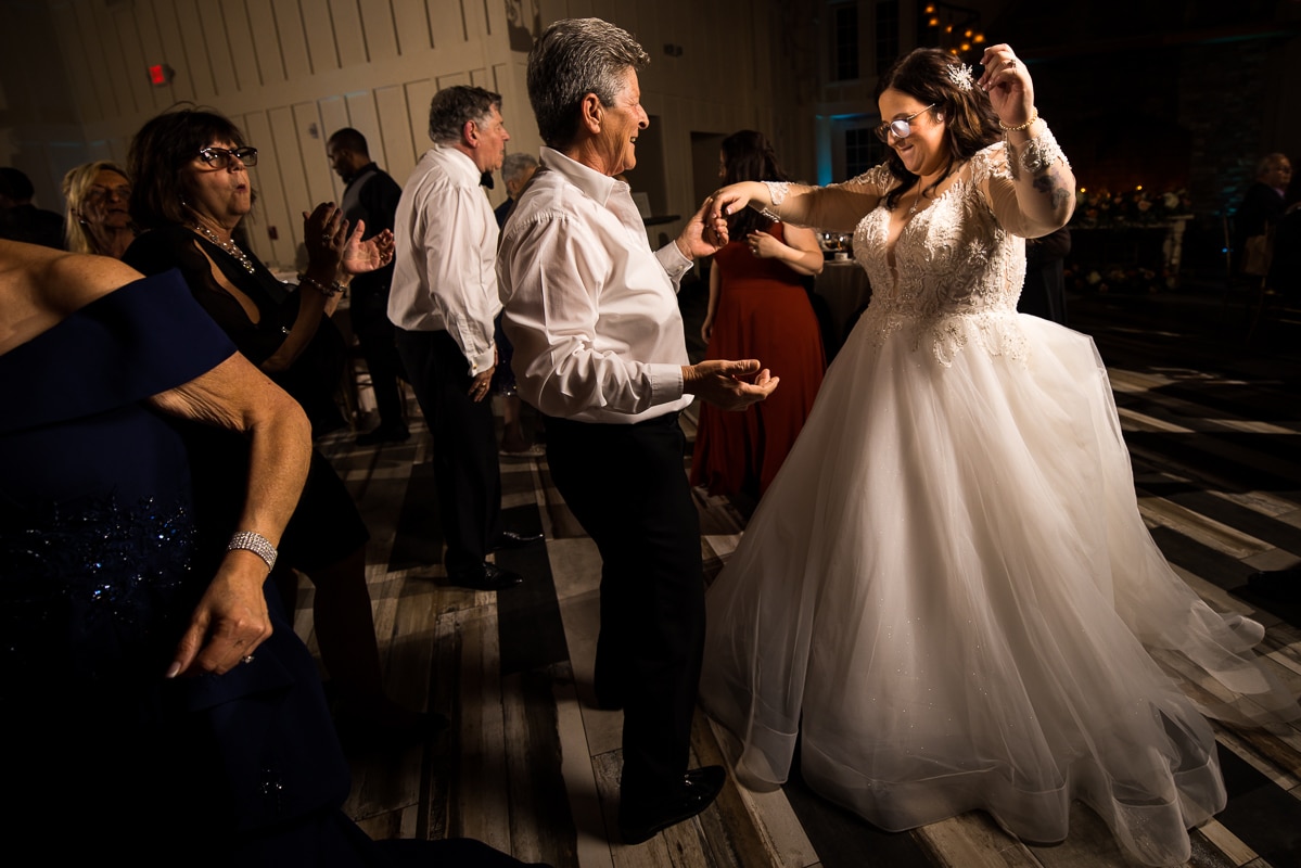 New Jersey photographer, lisa rhinehart, captures the bride dancing with one of the dads during the wedding reception