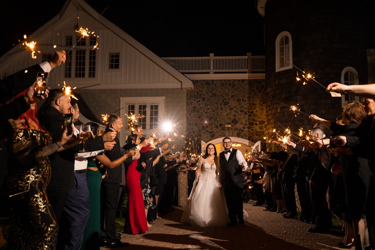 Ryland Inn Wedding Photographer, lisa rhinehart, captures the sparkler send off of the couple as they walk down holding hands between all of their guests at the end of their wedding reception at the ryland inn 