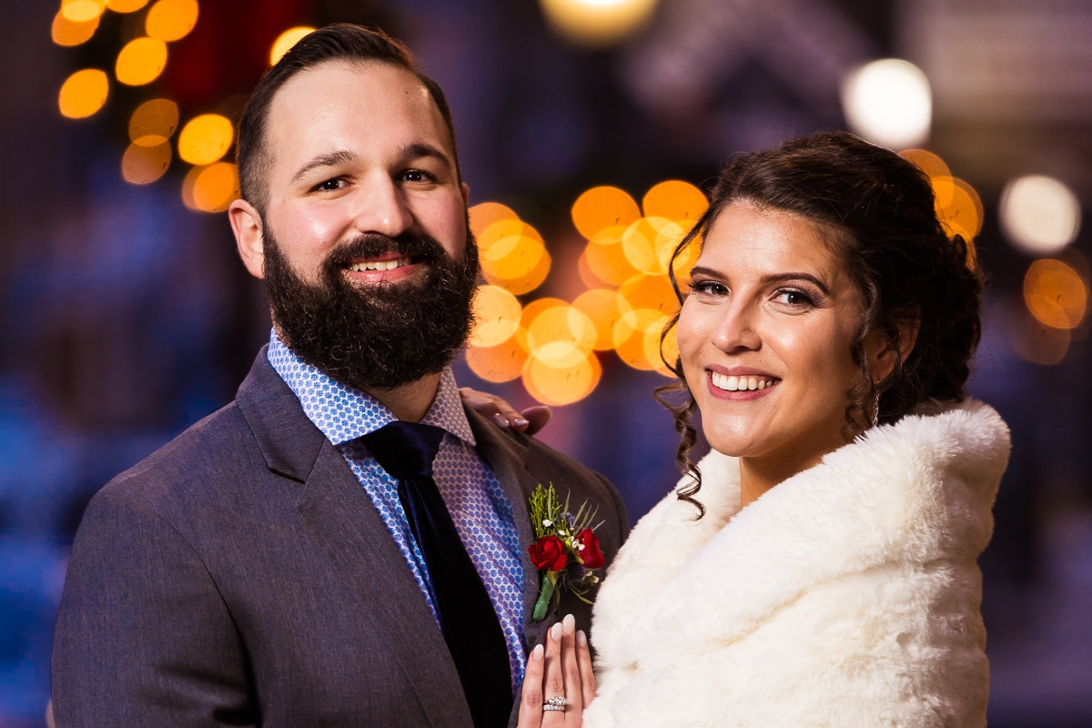 unique, creative, vibrant, fun image of the couple with twinkling Christmas lights behind them during their winter Gettysburg Hotel Wedding