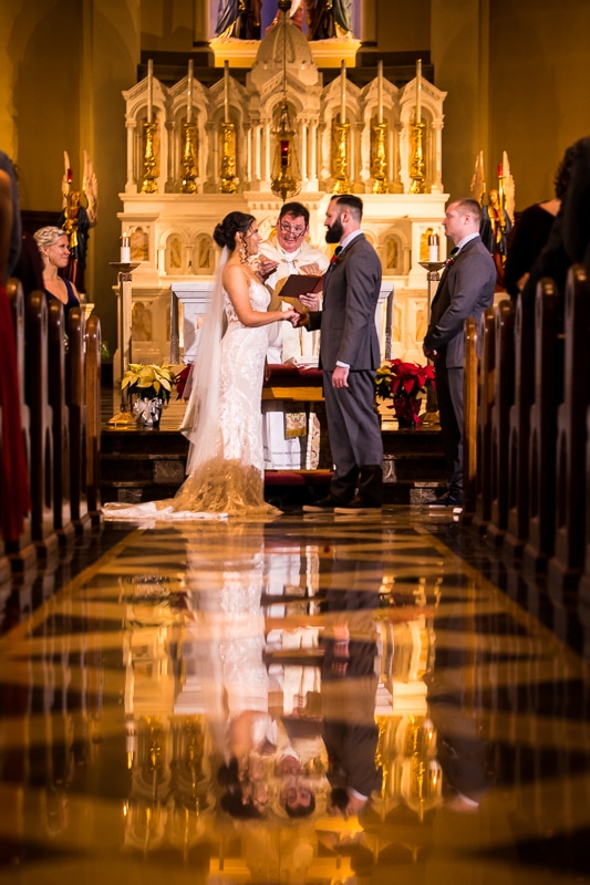 Gettysburg Hotel Wedding photographer, lisa rhinehart, captures this unique, creative, authentic image of the bride and groom at the altar during their wedding ceremony at mount st marys