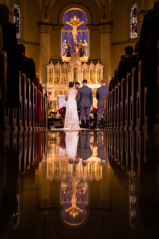 unique, creative, vibrant image of the bride and groom during their wedding ceremony at mount st marys captured by Gettysburg Hotel Wedding photographer, lisa rhinehart