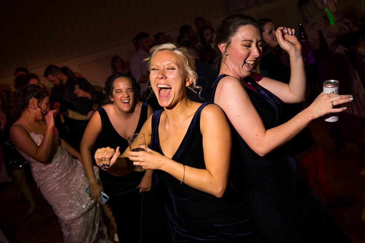 wedding photographer, lisa rhinehart, captures guests singing and dancing together during this Gettysburg hotel reception 