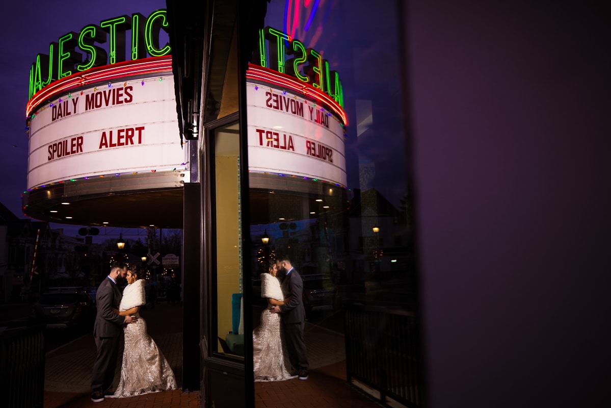 creative, unique perspective of the couple underneath the majestic theater in Gettysburg for their night shots after their Gettysburg Hotel Wedding