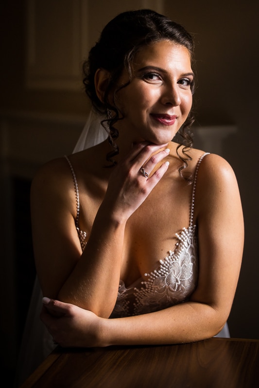 Traditional portrait of the bride smiling towards the camera in dramatic natural light before her mount st mary's wedding ceremony 