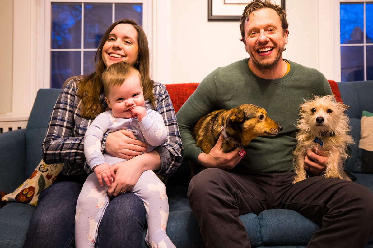 image of the family and dogs sitting together on the couch during their family session in their Pennsylvania home 