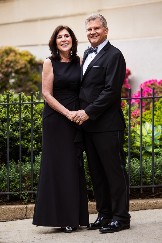 traditional portrait captured by dc wedding photographer, rhinehart photography, of the mother and father standing together holding hands outside of the wedding venue during their family portrait session of the day 