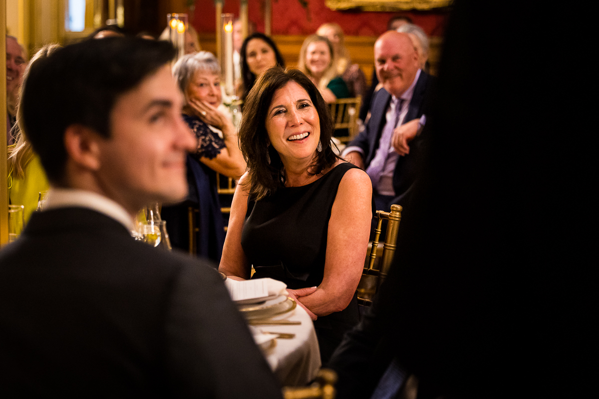 Dc wedding photographer captures these authentic, candid smiles as they listen to the father of the bride give his speech at this dc wedding reception 