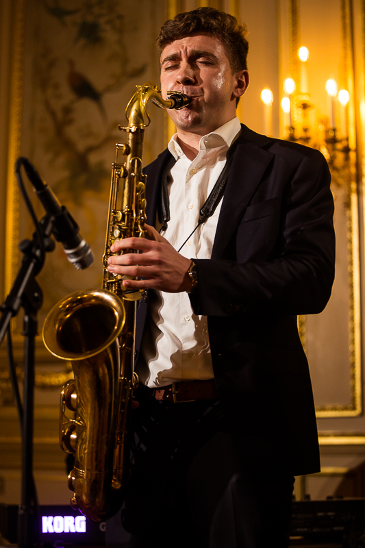 Perry Belmont House Wedding Photographer, lisa rhinehart, captures this saxophone player as he plays live music during the wedding reception at the belmont house 