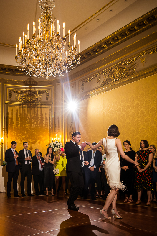 Dc wedding photographer, lisa rhinehart, captures this bride and grooms first dance as their guests standing around them watching 