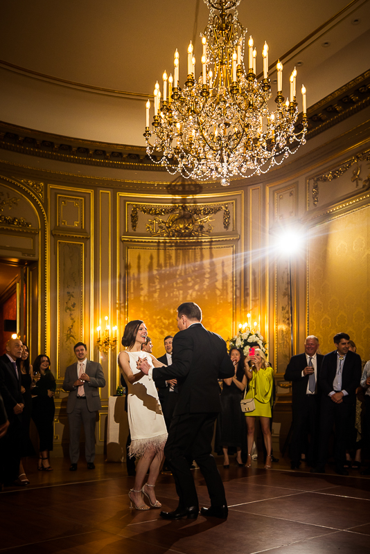 Perry Belmont House Wedding Photographer, rhinehart photography, captures the couple dancing together under this elegant chandelier during their wedding reception inside of this dc wedding venue