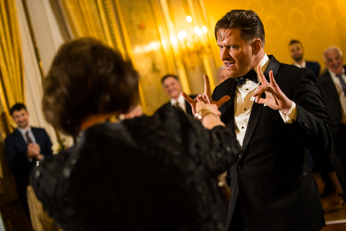 wedding photographer, lisa rhinehart, captures this fun, unique image of the groom dancing with guests at this dc wedding reception 