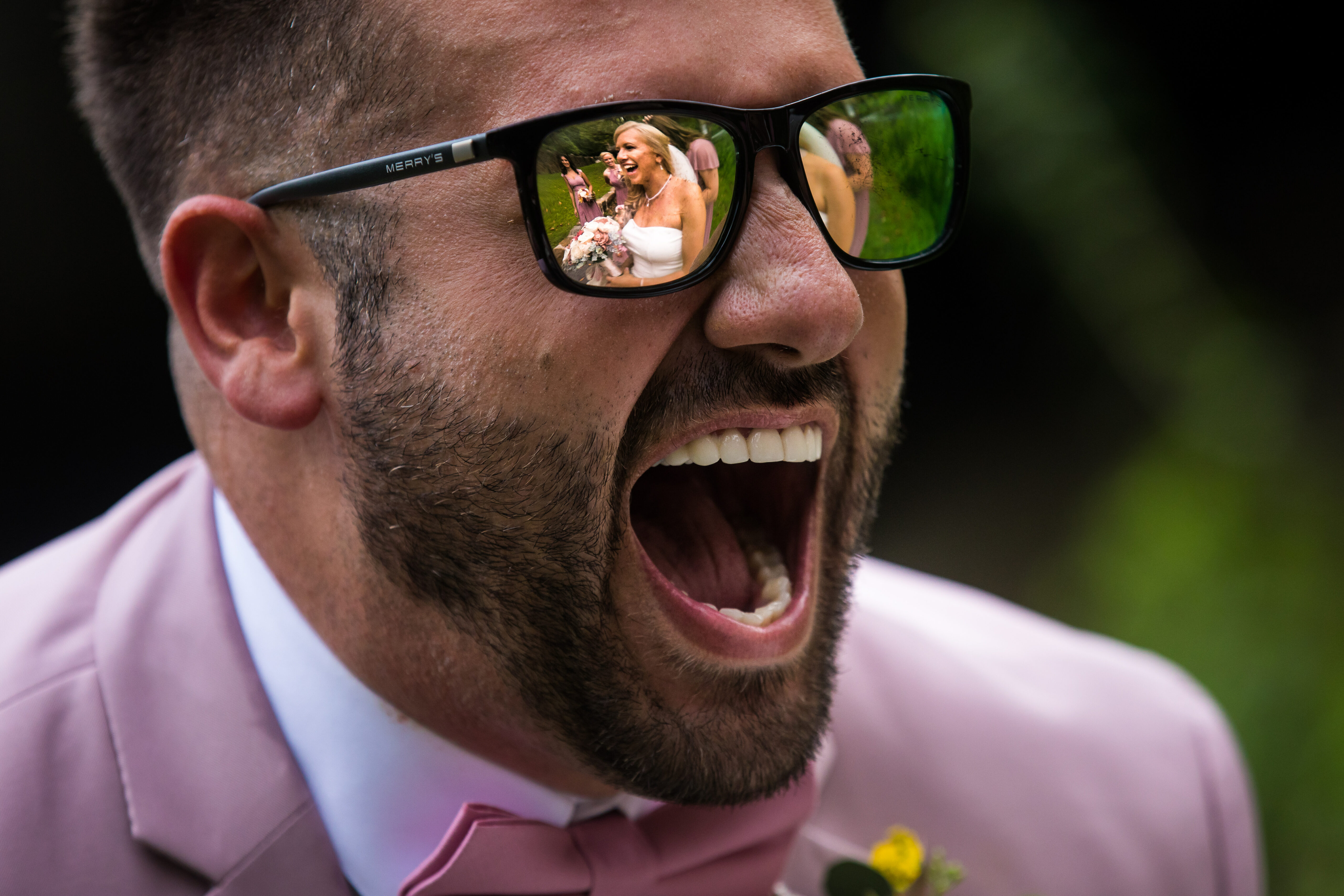 Creative PA Wedding Photographer, Lisa Rhinehart, captures this authentic image of  this bridesman smiling at the bride as he sees her for the first time caught through the reflection in his glasses