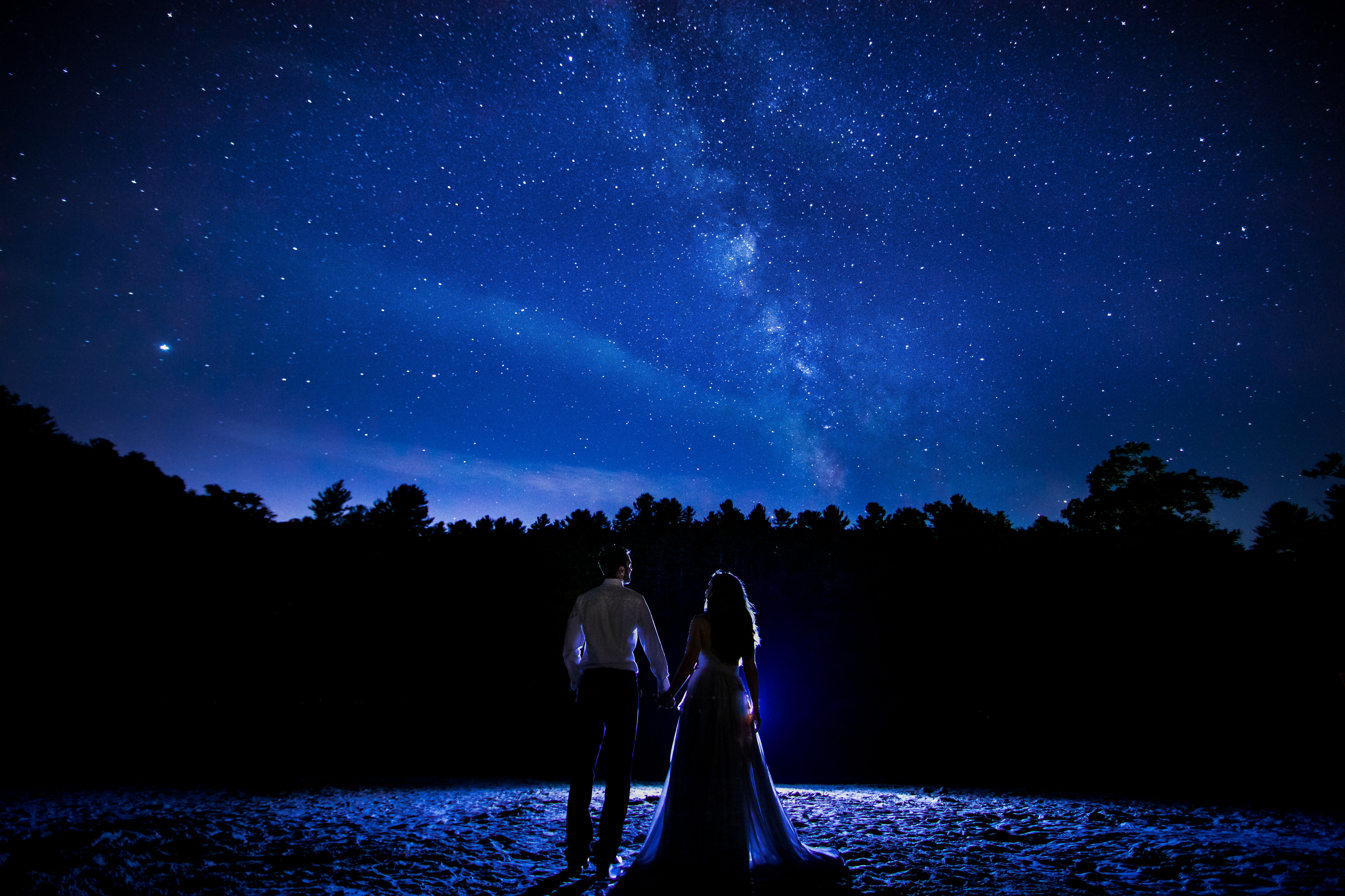 Creative Central PA Engagement Photographer, Lisa Rhinehart, captures this unique, colorful, fun image of the couple holding hands as they stare at the Milky Way during their after session photoshoot