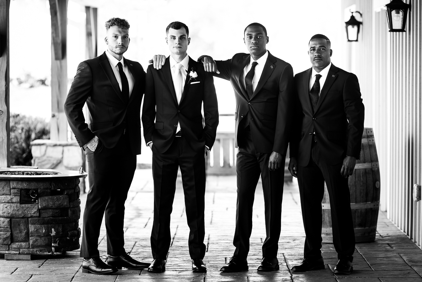 traditional black and white image of the groom with his groomsmen outside of the middleburg barn before their wedding ceremony in Virginia 