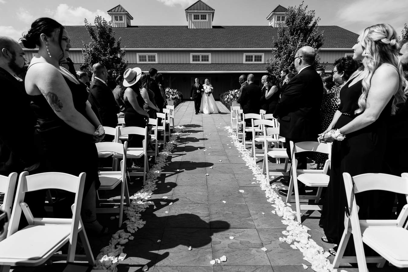 Middleburg Barn Wedding Photographer, lisa rhinehart, captures this black and white image of the bride and her father as they walk down the aisle together during the wedding ceremony 
