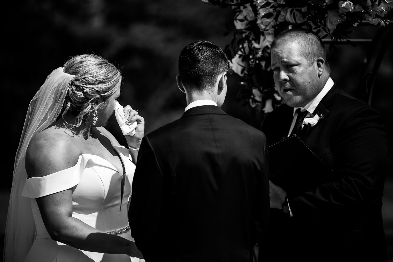 authentic virginia wedding photographer, lisa rhinehart, captures this authentic image of the bride as she wipes tears away with a tissue during their vows 