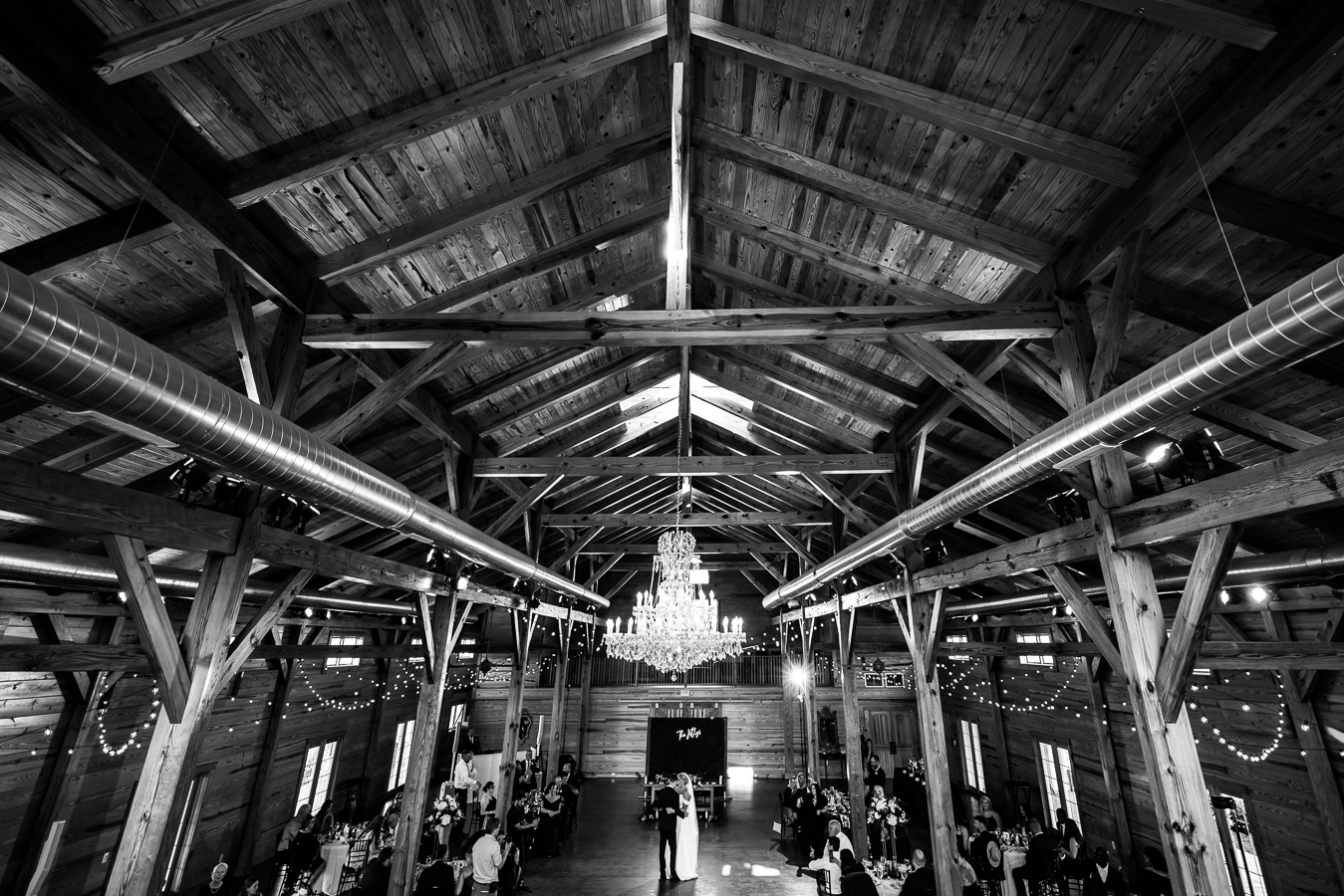 Middleburg Barn Wedding Photographer, lisa rhinehart, captures this unique, creative image of the couple sharing their first dance with the architecture of the building featured in the image 
