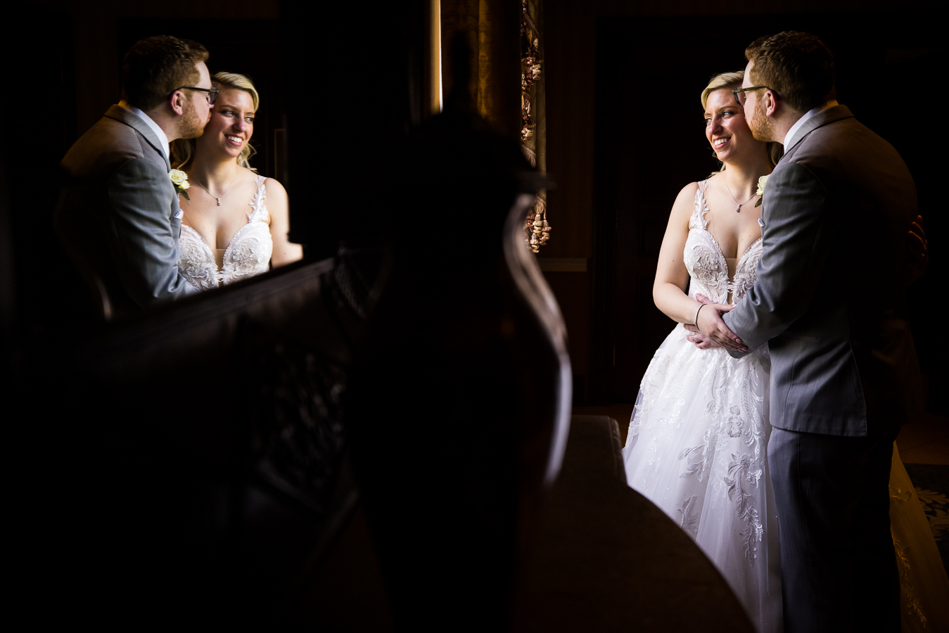 creative NJ Wedding Photographer, lisa rhinehart, captures this unique, creative image of the couple kissing one another on the cheek caught through the reflection of the mirror for their palace at somerset park wedding
