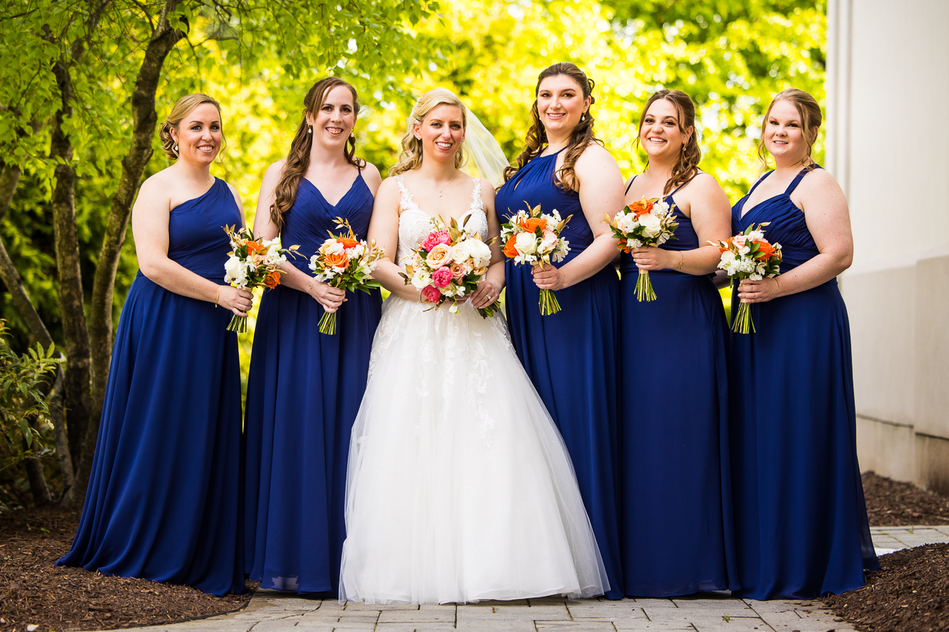 new jersey wedding photographer, lisa rhinehart, captures this traditional image of the bride with her bridesmaid before their creative, unique wedding at the palace at somerset park