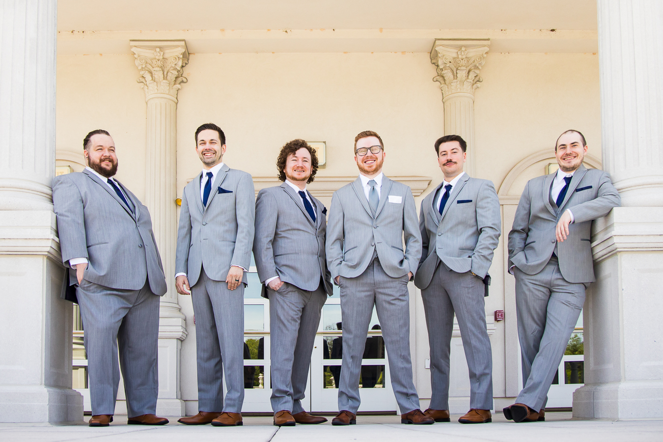 palace at somerset park wedding photographer, lisa rhinehart, captures this traditional image of the groom with his groomsmen standing outside of the palace before their wedding ceremony in new jersey 